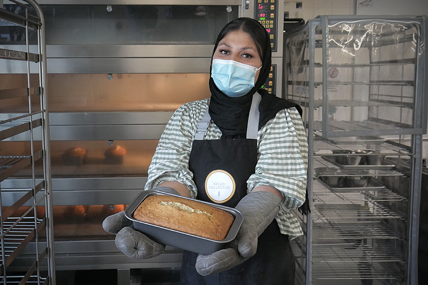 Ziba Eidizada holding a loaf of bread.