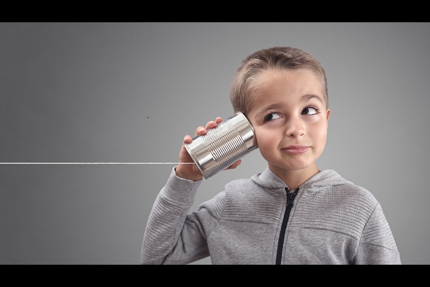 Child with tin can phone