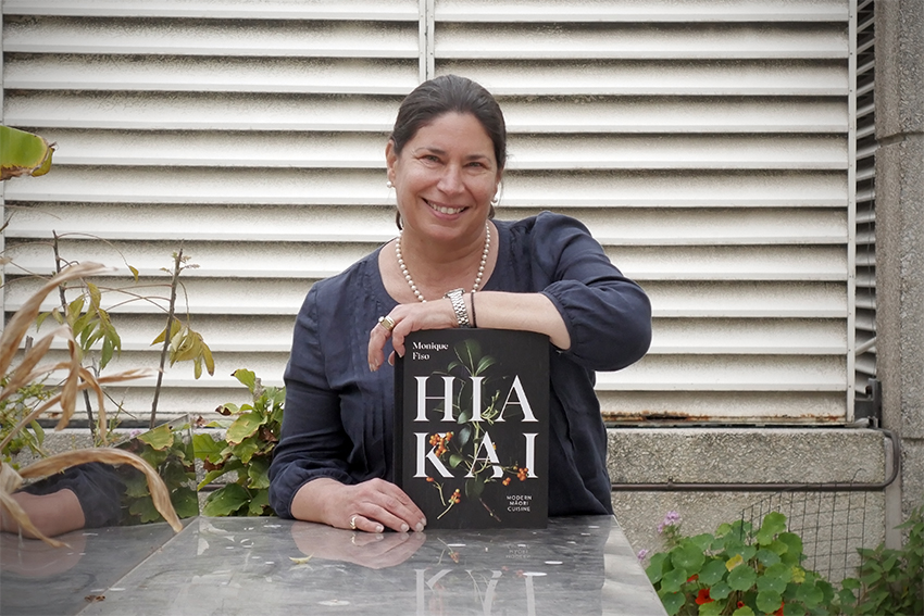 Hia Kai 850x567.jpg Tracy Berno holding the book Hiakai and smiling.