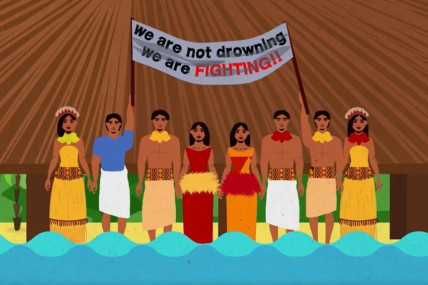 Screenshot of the video showing people of Kiribati holding a sign that says "we are not drowning, we are fighting!!"